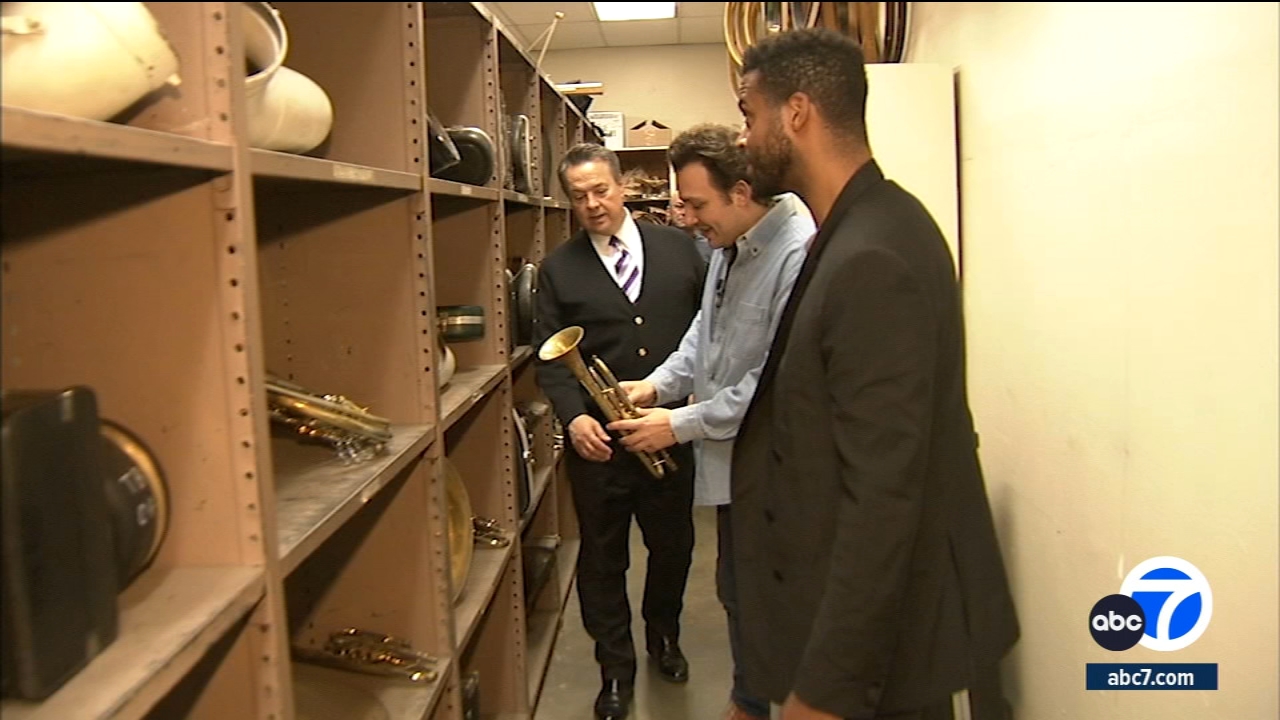 Directors Ben Proudfoot and Kris Bowers tour the instrument storage room