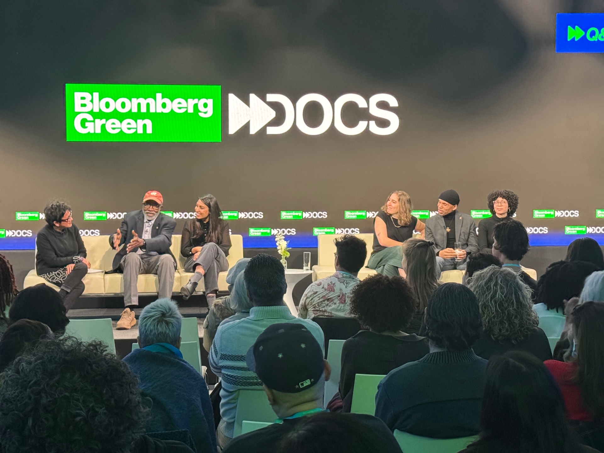 Six-person panel on stage at Bloomberg Green Docs beneath the event logo.