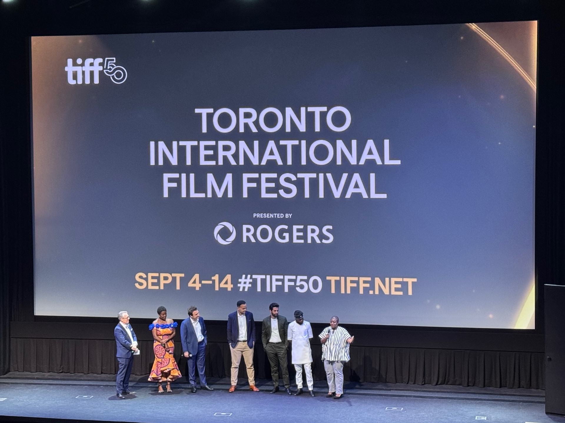 Agency client team on stage at the Toronto International Film Festival premiere beneath the TIFF50 screen.
