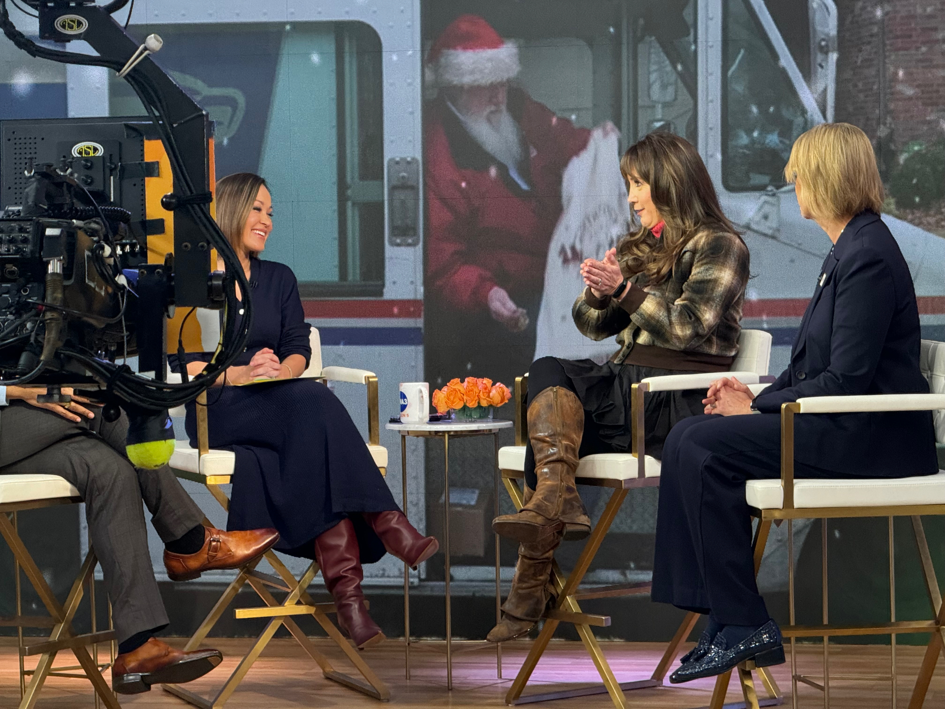 Television host interviews Dear Santa guests during a live studio segment.