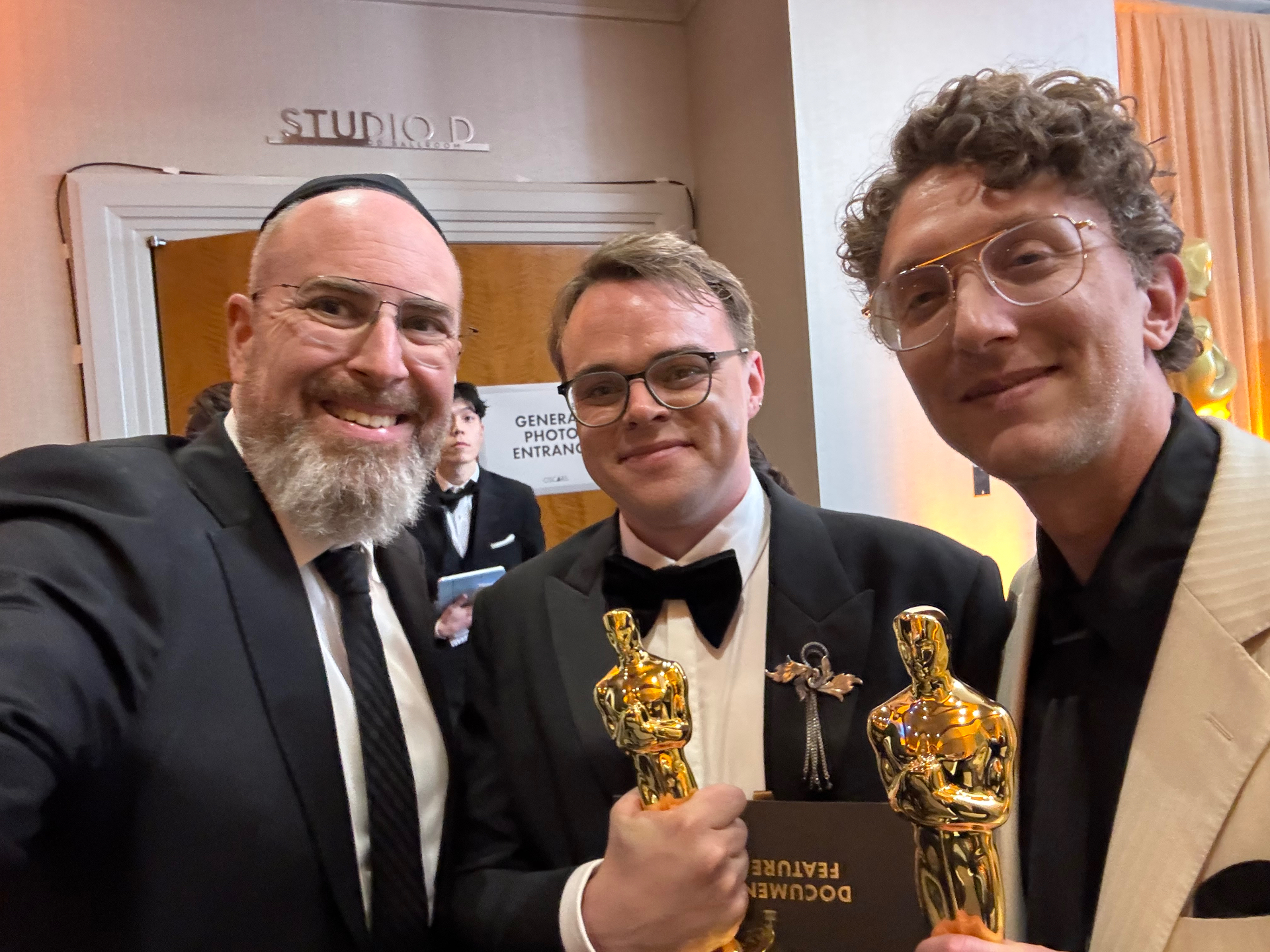 Agency client filmmakers backstage at the Oscars holding Documentary Feature statuettes