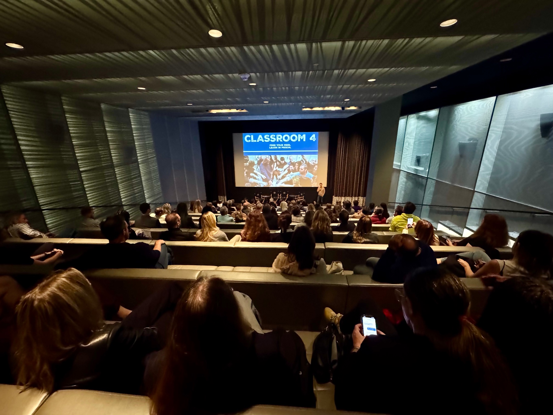 Wide view of a packed Classroom 4 FYC screening with talent on stage
