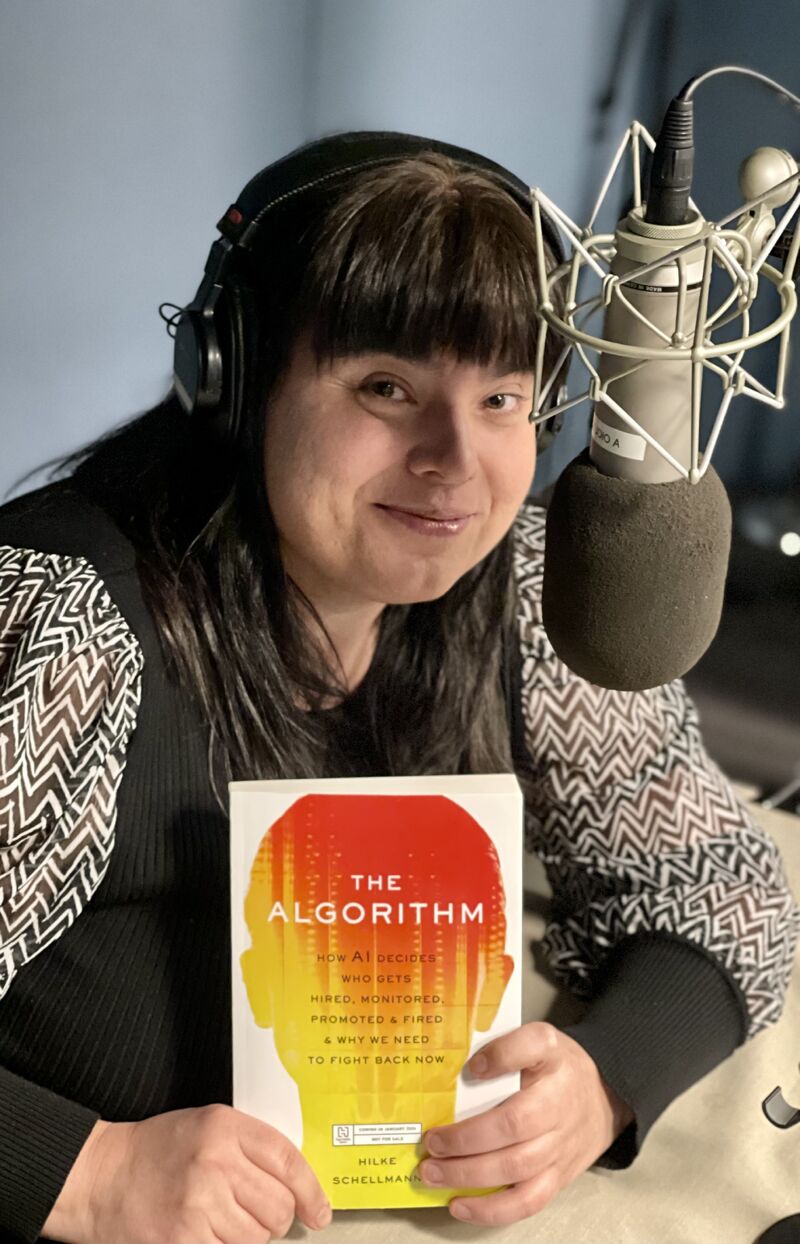 Hilke Schellmann in a podcast studio holding The Algorithm