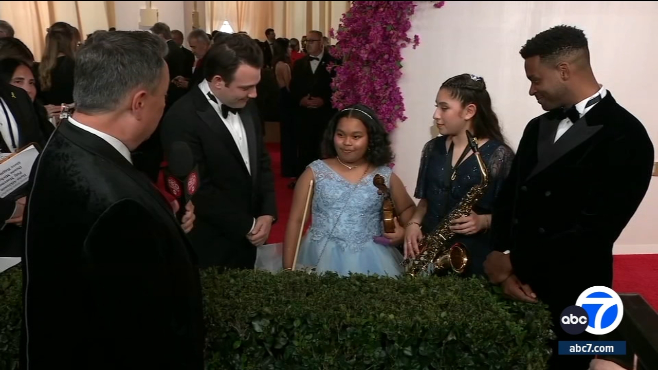 Student musicians on the Oscars® red carpet with directors Ben Proudfoot and Kris Bowers
