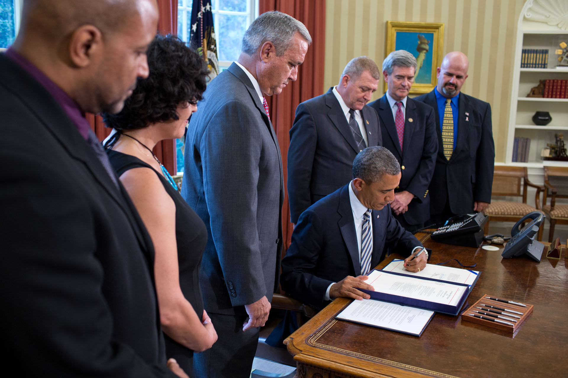 President Obama signs the Honoring America's Veterans and Caring for Camp Lejeune Families Act of 2012 in the Oval Office